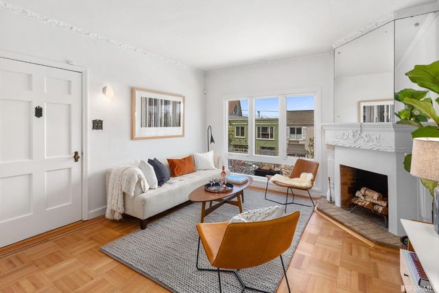 a living room with furniture and a fireplace