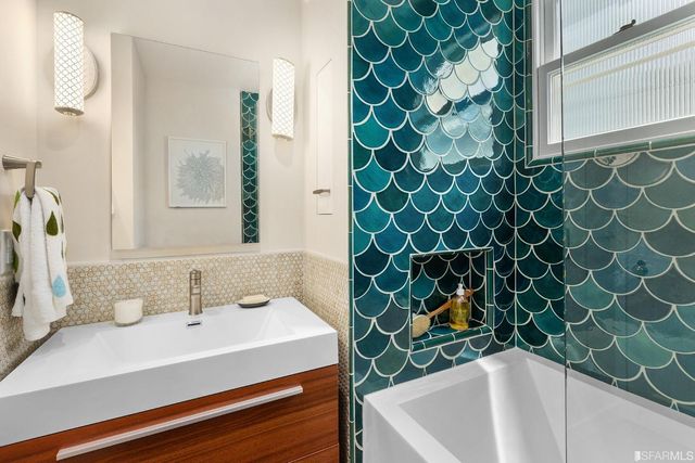 a bathroom with a bathtub and shower