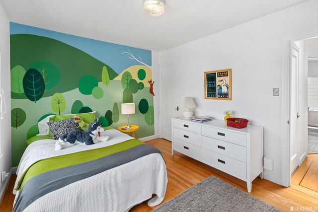 a bedroom with two beds and a large window