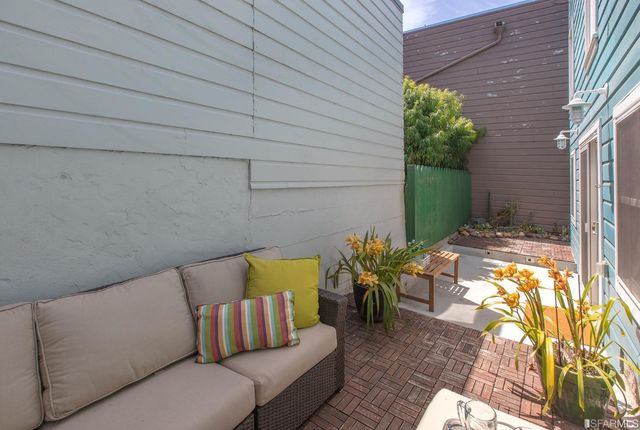 a view of balcony with chairs and potted plants