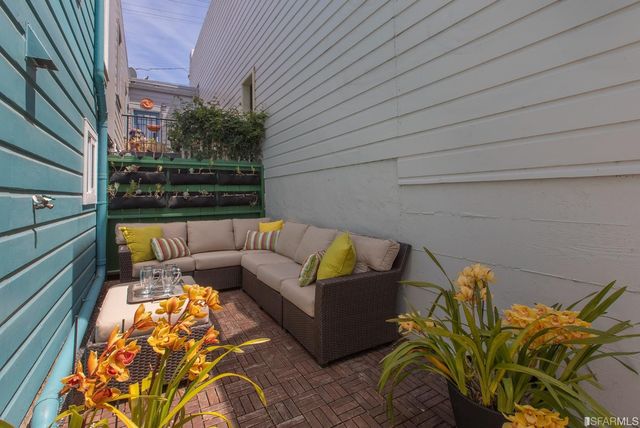 a backyard of a house with outdoor seating