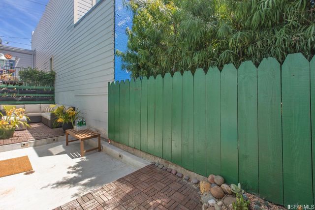 a view of a backyard with plants and outdoor seating