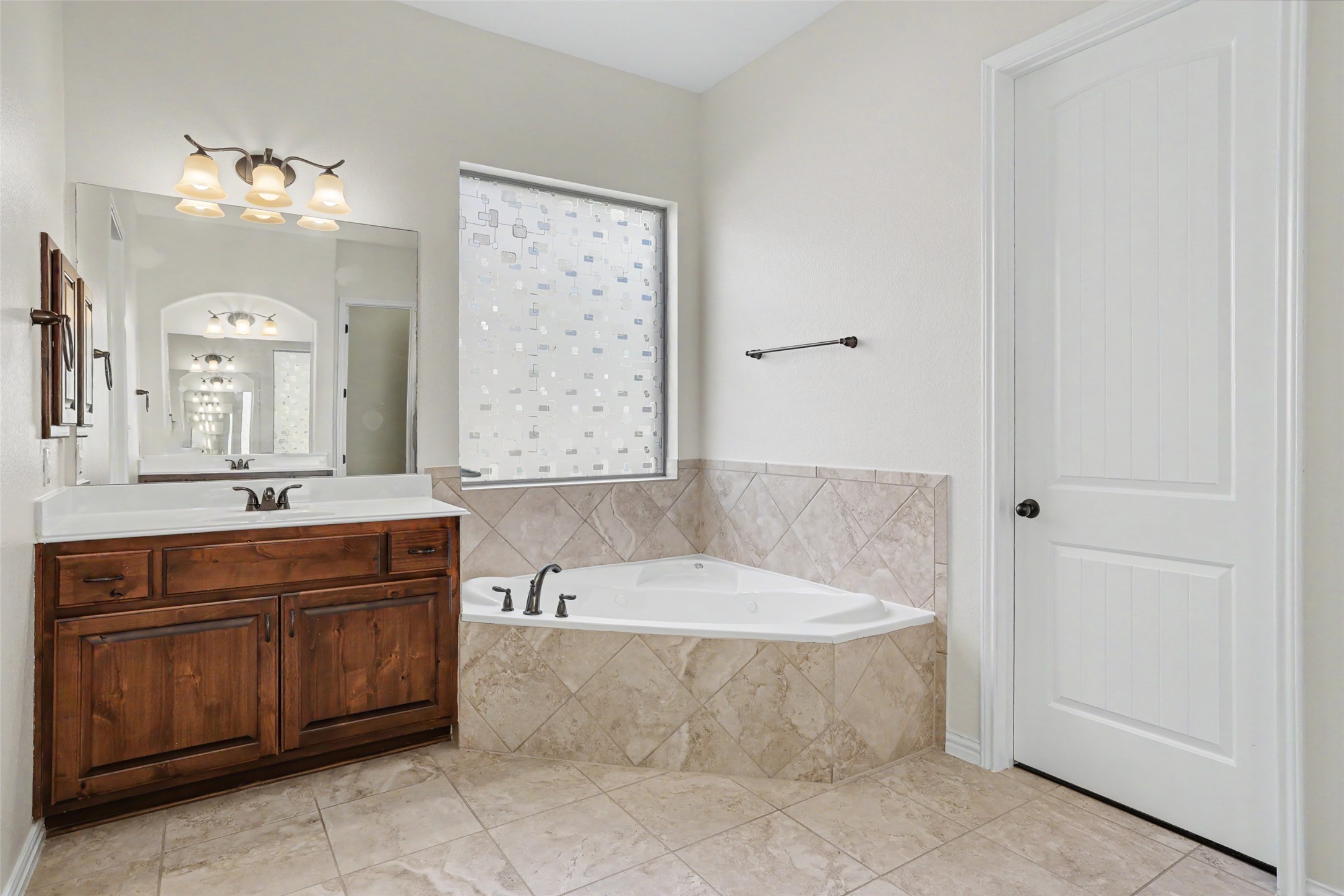 1020 Winding Way Drive Georgetown, TX 78628 - Photo 16 of 32 Bathroom with vanity, a bath, and light tile patterned flooring