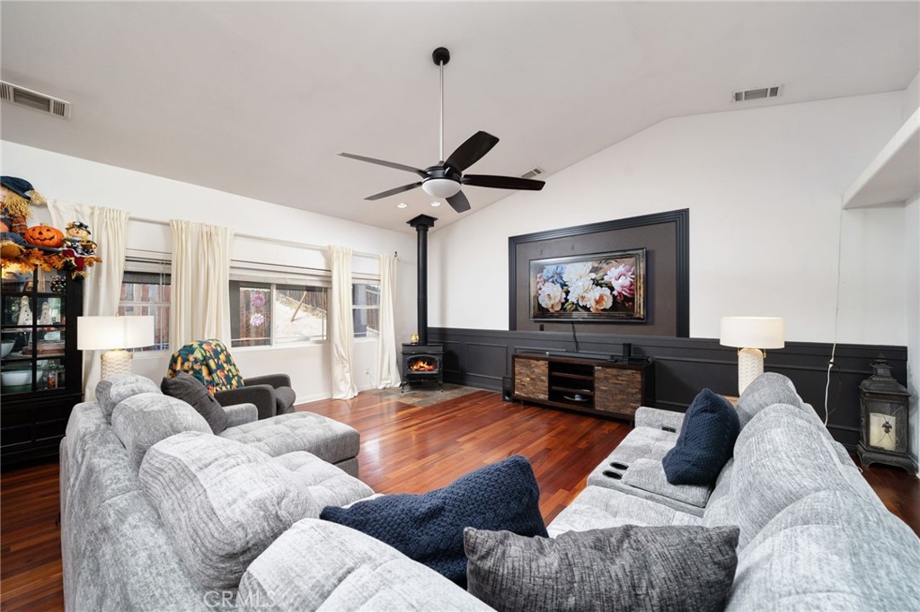 7575 Rancho Road Pinon Hills, CA 92397 - Photo 14 of 38 a living room with furniture a fireplace and a flat screen tv