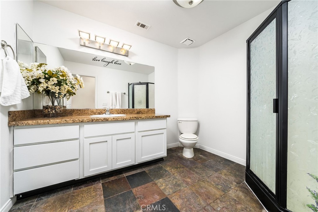 7575 Rancho Road Pinon Hills, CA 92397 - Photo 19 of 38 a bathroom with a toilet sink and mirror