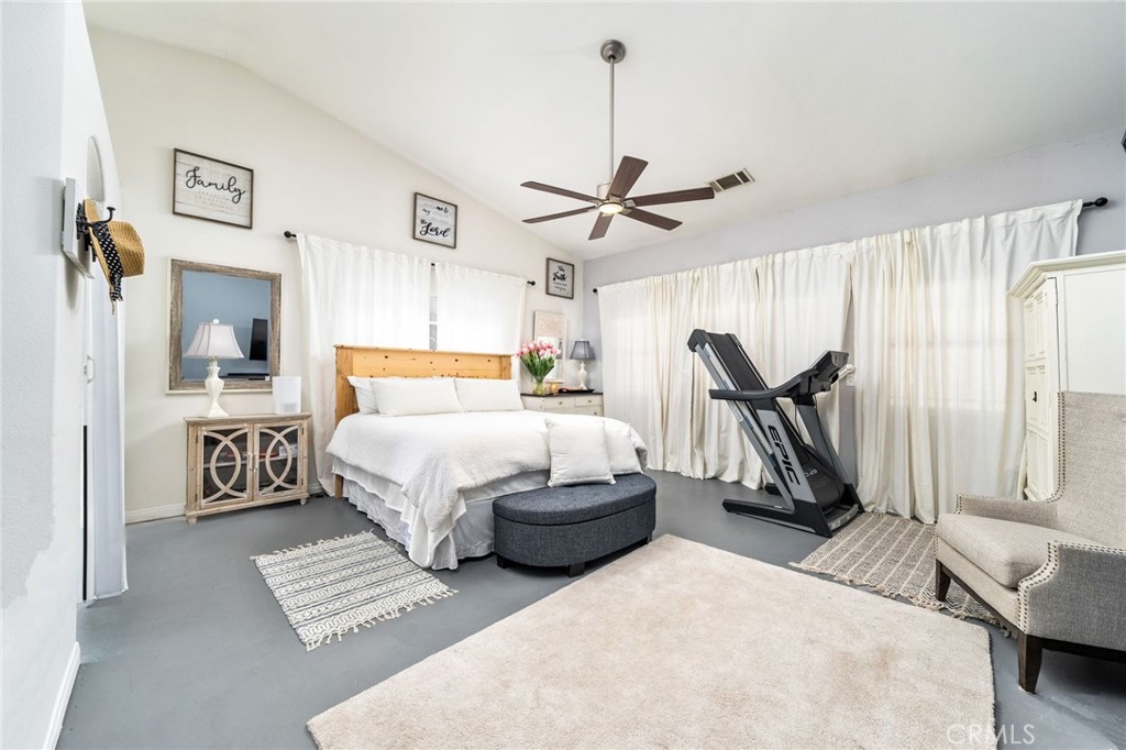 7575 Rancho Road Pinon Hills, CA 92397 - Photo 20 of 38 a bedroom with a bed next to a window and a chandelier