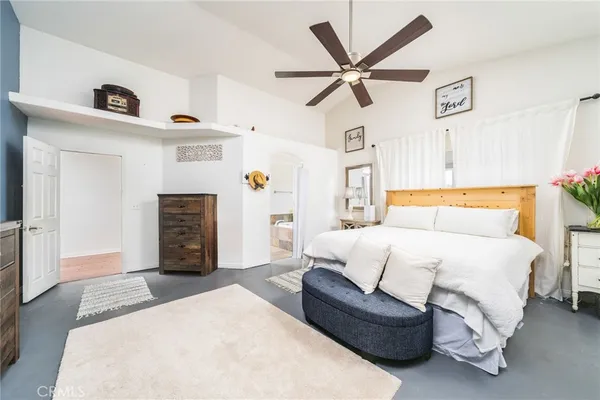 a bedroom with a bed and ceiling fan