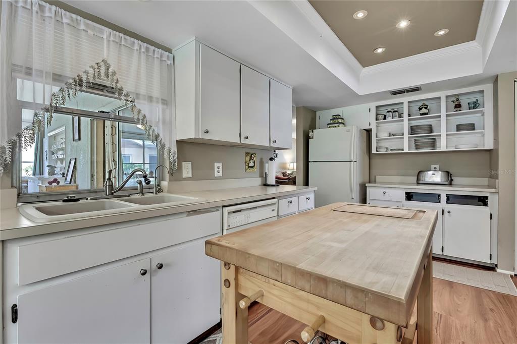 6517 Ocean Pines Lane Spring Hill, FL 34606 - Photo 11 of 72 a kitchen with a sink a stove and cabinets