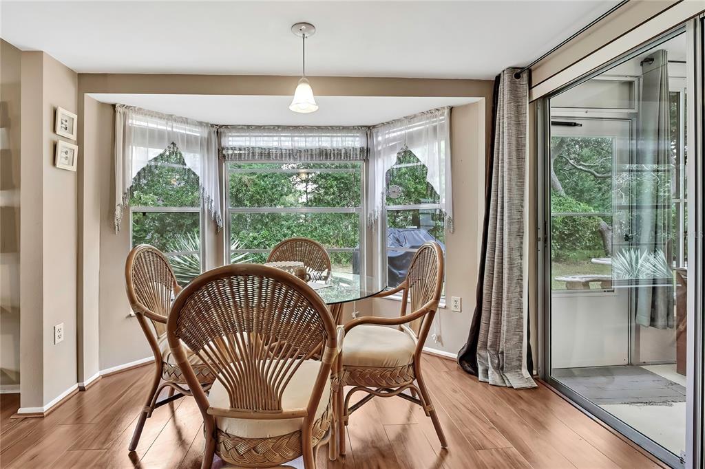 6517 Ocean Pines Lane Spring Hill, FL 34606 - Photo 12 of 72 a view of a dining room with furniture window and wooden floor