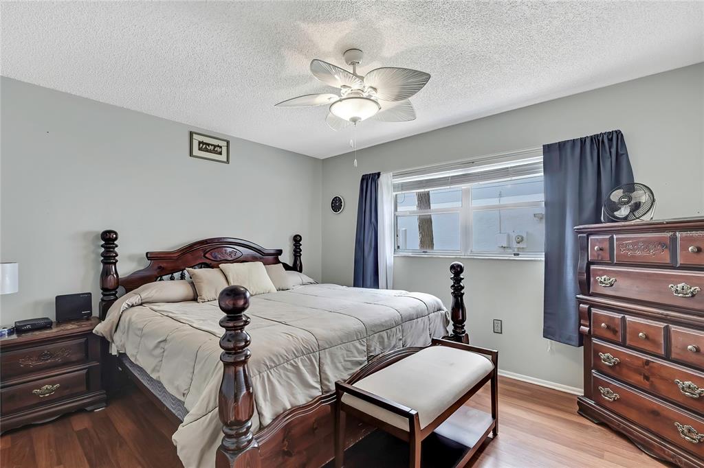 6517 Ocean Pines Lane Spring Hill, FL 34606 - Photo 22 of 72 a bedroom with a bed and dresser with wooden floor