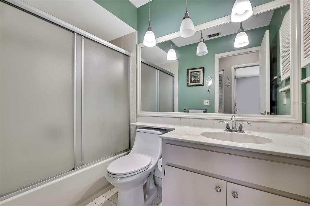6517 Ocean Pines Lane Spring Hill, FL 34606 - Photo 24 of 72 a bathroom with a sink vanity mirror and toilet