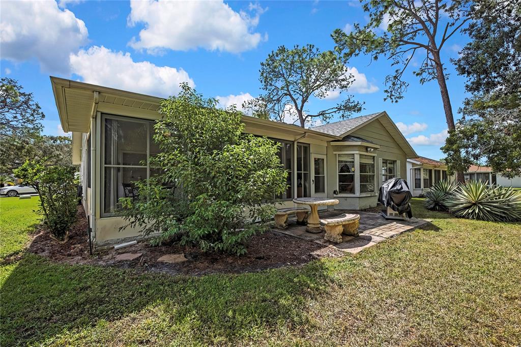 6517 Ocean Pines Lane Spring Hill, FL 34606 - Photo 32 of 72 a view of a house with backyard garden and sitting area