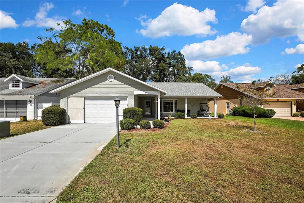 6517 Ocean Pines Lane Spring Hill, FL 34606 - Photo 38 of 72 a front view of a house with a yard