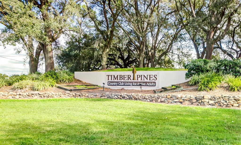 6517 Ocean Pines Lane Spring Hill, FL 34606 - Photo 41 of 72 a sign that is sitting in front of a tree