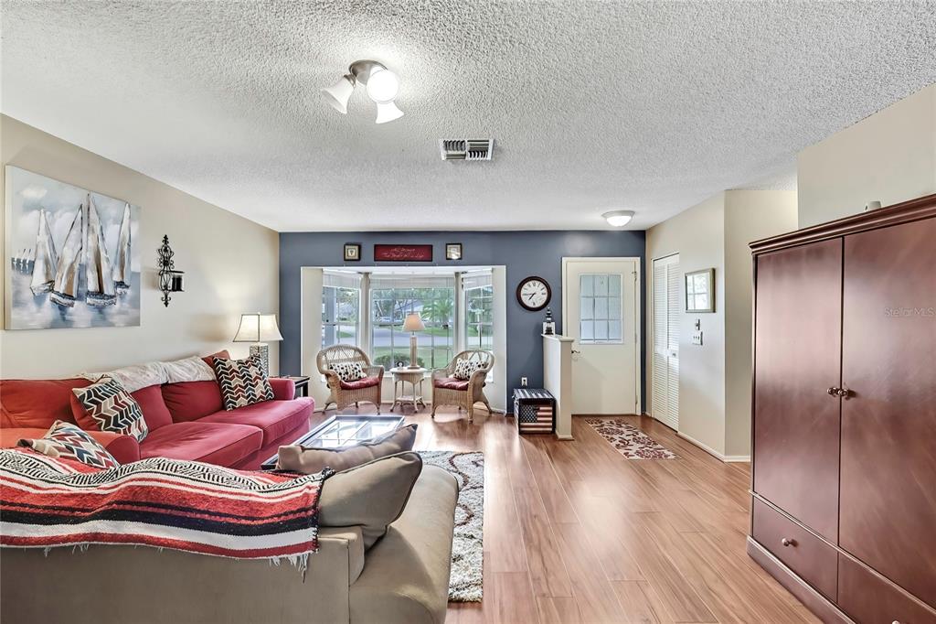 6517 Ocean Pines Lane Spring Hill, FL 34606 - Photo 5 of 72 a living room with furniture and a large window