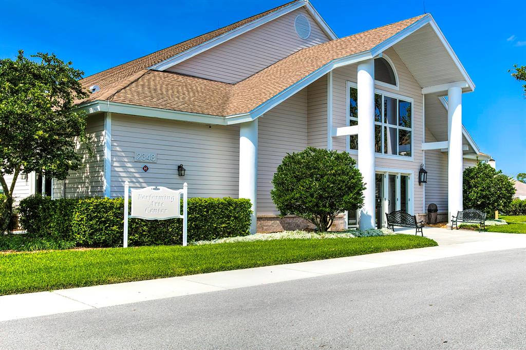 6517 Ocean Pines Lane Spring Hill, FL 34606 - Photo 62 of 72 a front view of a house with a yard and garage