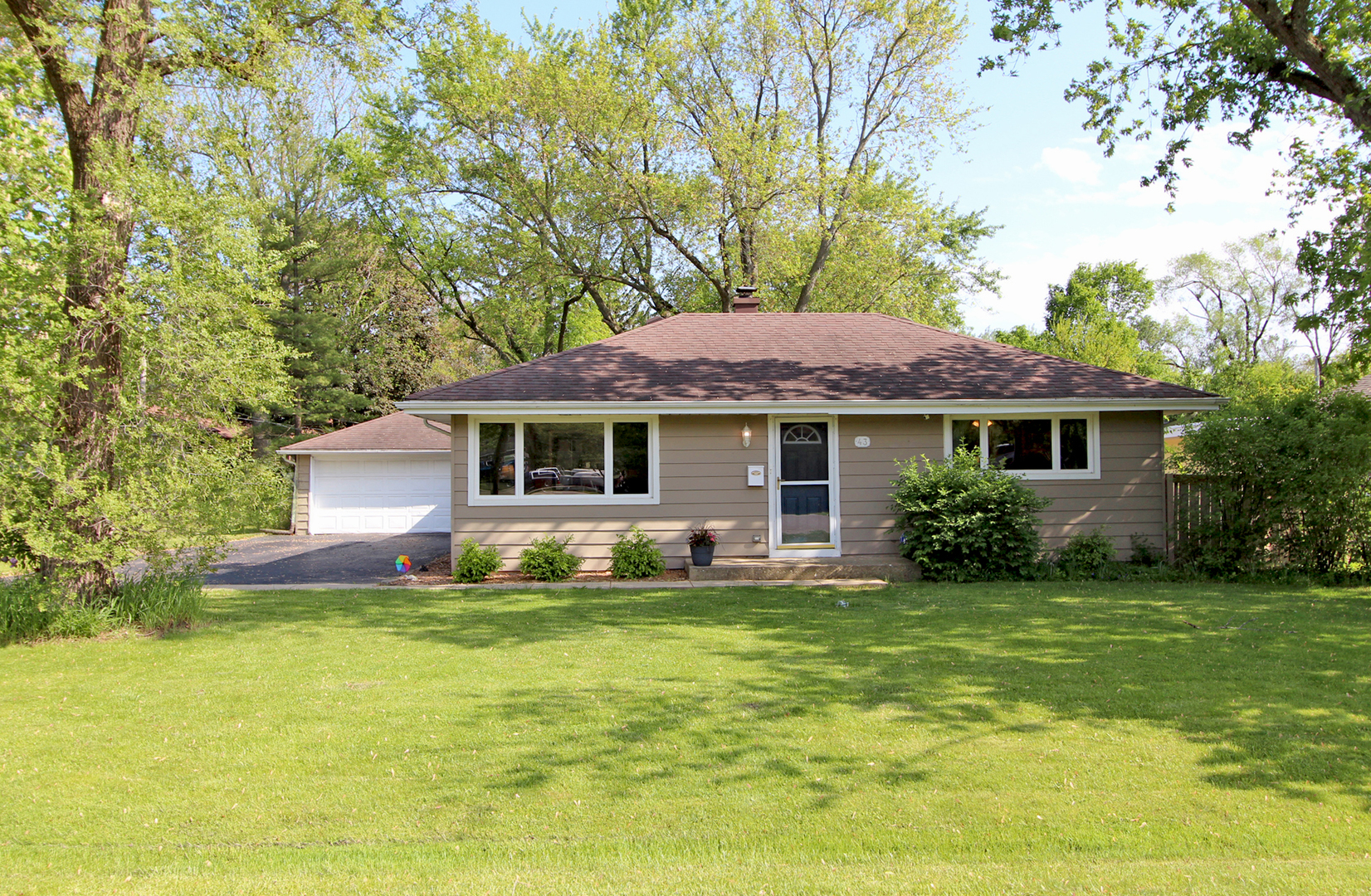 a view of a house with a yard porch and sitting area