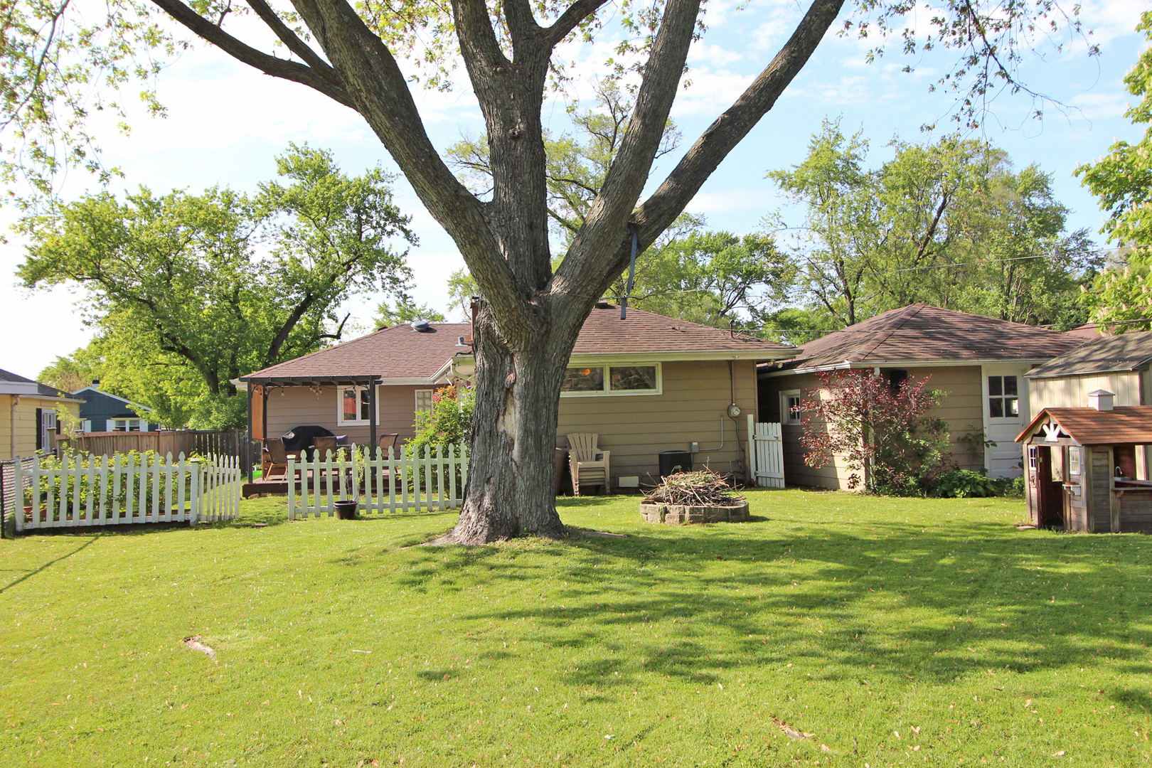 43 Golfview Road Lake Zurich, IL 60047 - Photo 26 of 35 a front view of a house with a yard table and chairs