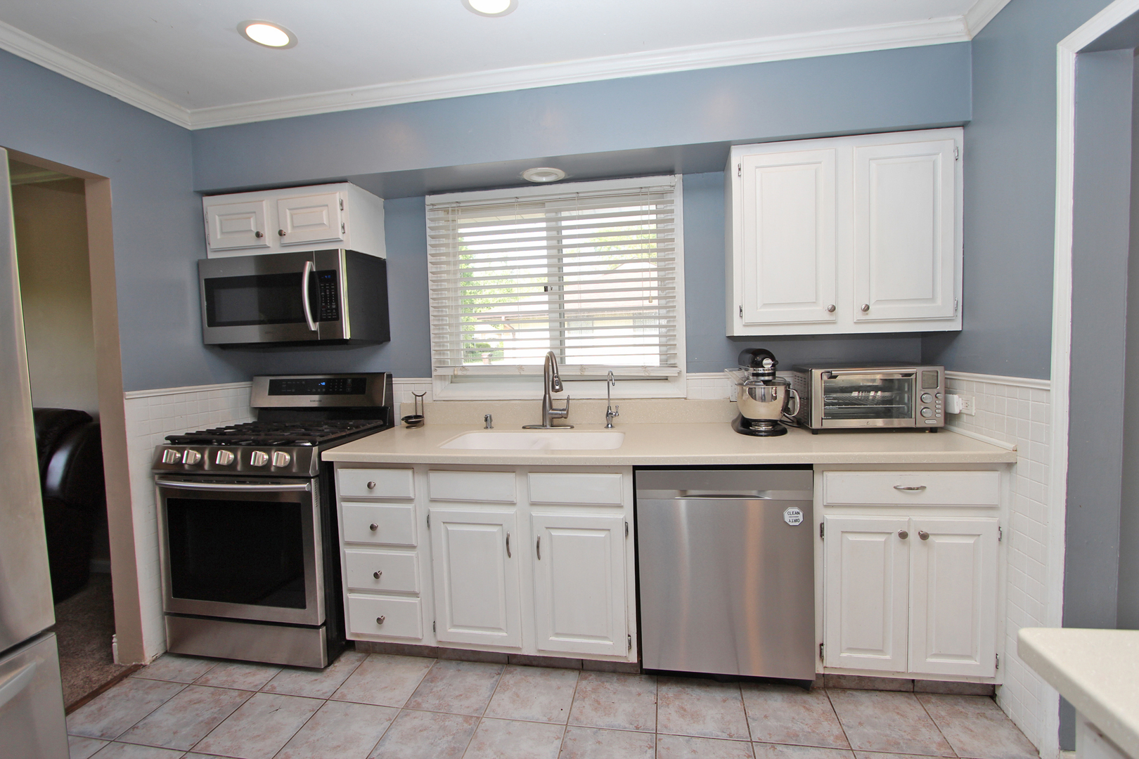 43 Golfview Road Lake Zurich, IL 60047 - Photo 7 of 35 a kitchen with white cabinets and appliances