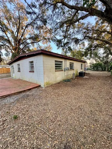 a backyard of a house with large trees
