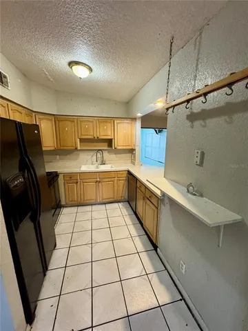a kitchen with washing machine and sink