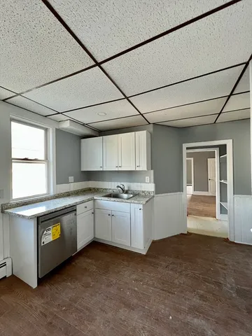 a large kitchen with a stove and a refrigerator