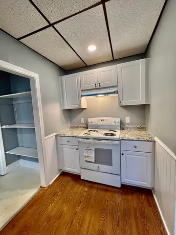 a kitchen with granite countertop cabinets stainless steel appliances and a sink