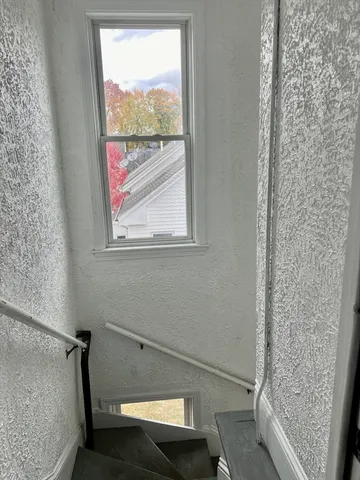 a bathroom with a window and a shower