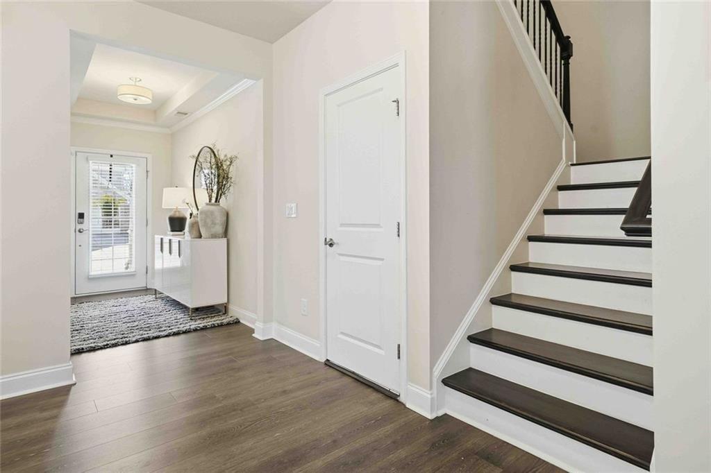 4631 Leader Lane Duluth, GA 30096 - Photo 12 of 55 a view of a hallway with wooden floor and entryway