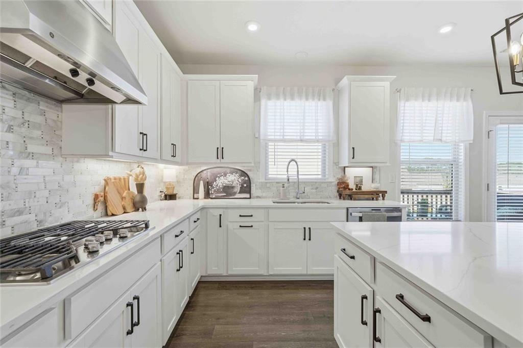 4631 Leader Lane Duluth, GA 30096 - Photo 19 of 55 a kitchen with a sink stove and cabinets