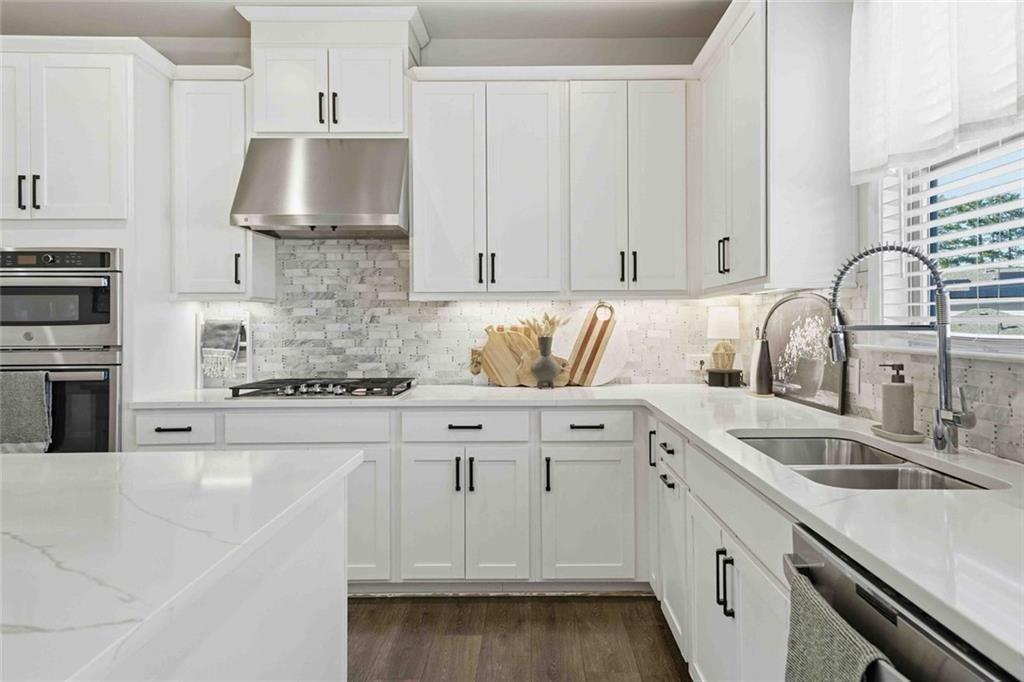 4631 Leader Lane Duluth, GA 30096 - Photo 21 of 55 a kitchen with stainless steel appliances granite countertop a sink a stove and cabinets