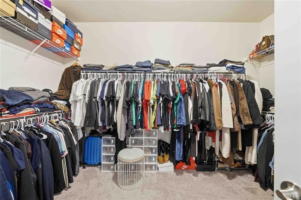 4631 Leader Lane Duluth, GA 30096 - Photo 34 of 55 a view of walk in closet with clothes and shoes