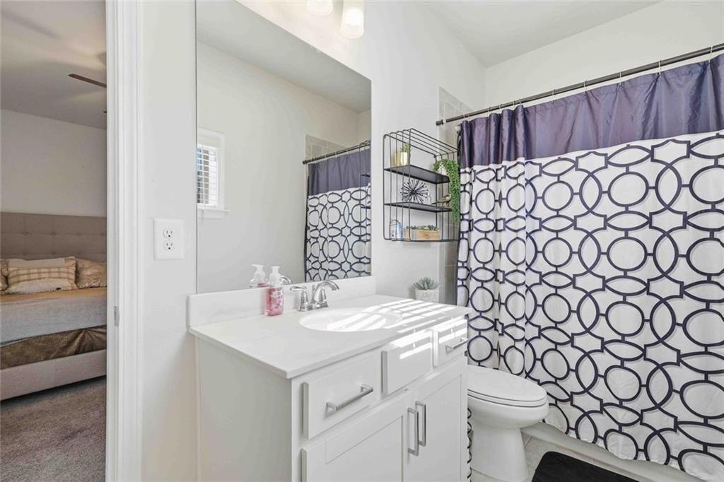 4631 Leader Lane Duluth, GA 30096 - Photo 38 of 55 a bathroom with a sink a toilet and shower curtain