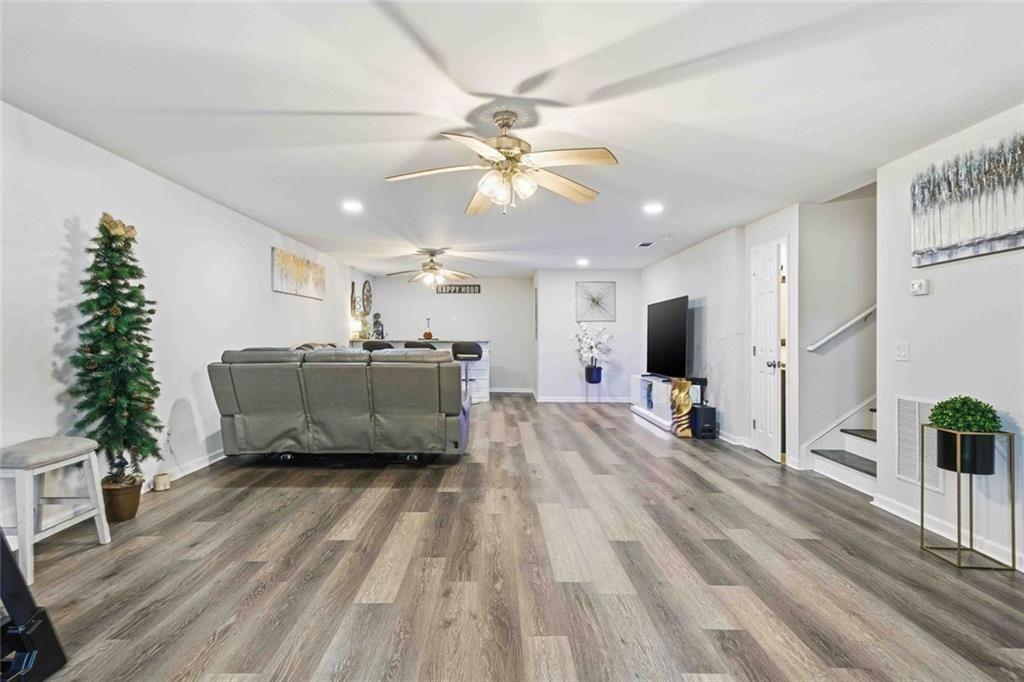 4631 Leader Lane Duluth, GA 30096 - Photo 41 of 55 a living room with furniture and a flat screen tv
