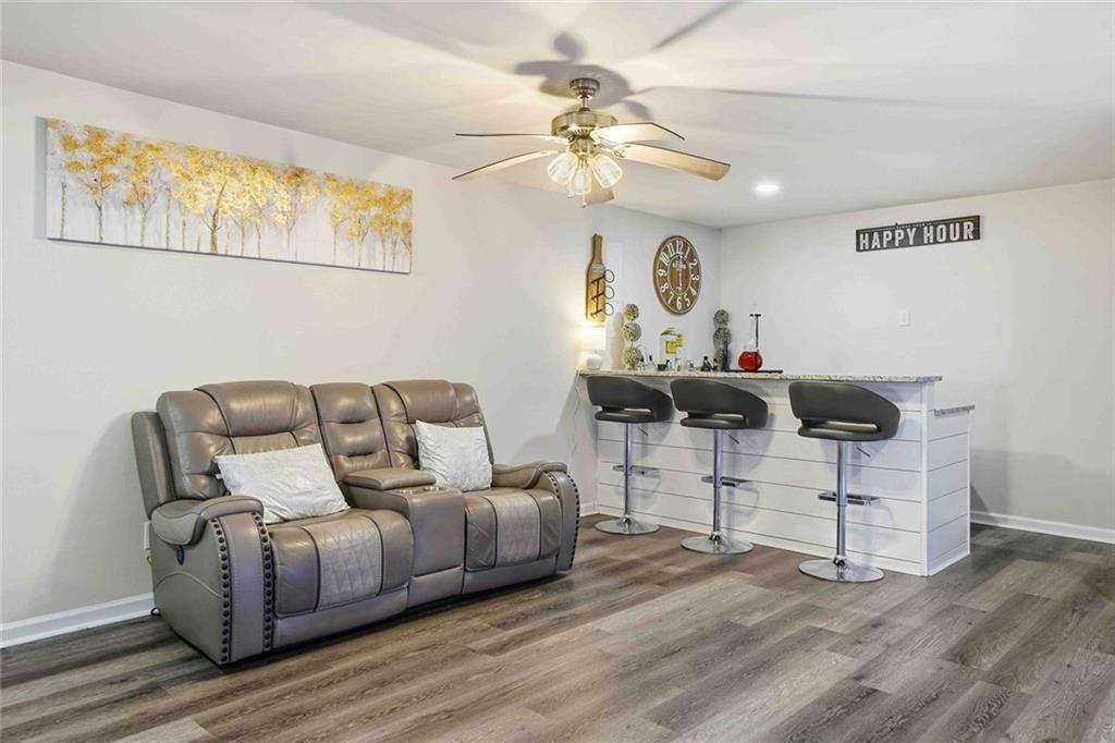 4631 Leader Lane Duluth, GA 30096 - Photo 42 of 55 a living room with furniture and a chandelier
