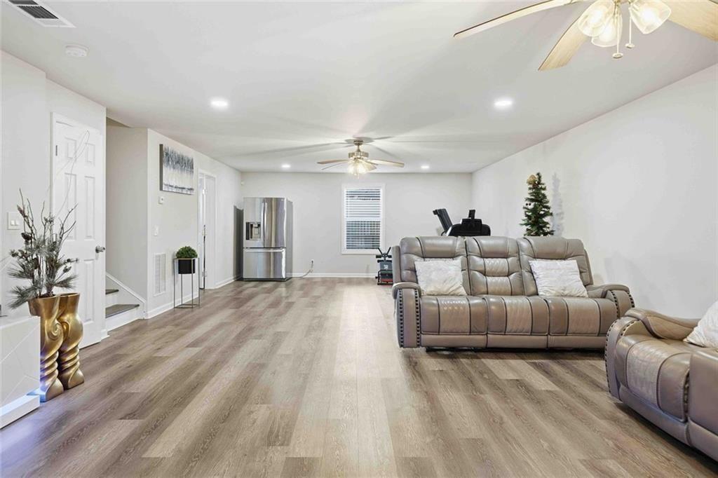 4631 Leader Lane Duluth, GA 30096 - Photo 43 of 55 a living room with furniture and a chandelier