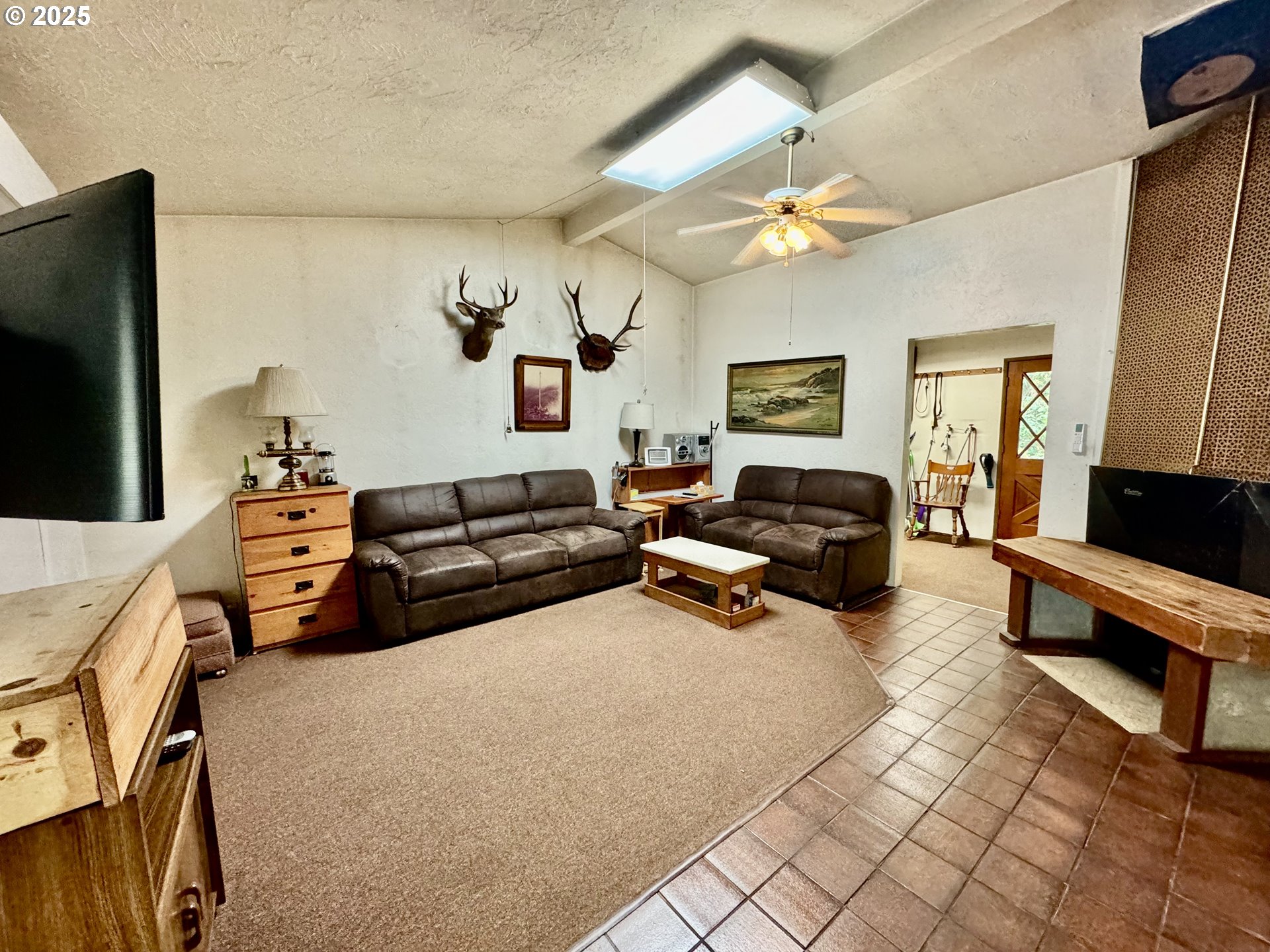 4990 Mitchell Loop Road Florence, OR 97439 - Photo 4 of 37 a living room with furniture and a flat screen tv