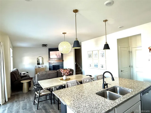 a kitchen with a kitchen island a sink a dining table and chairs