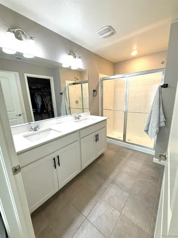 a bathroom with a sink mirror and a bath tub
