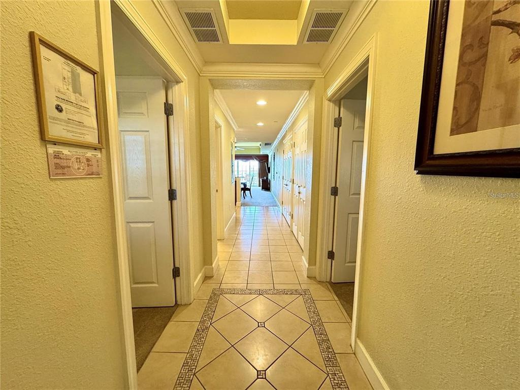1350 Centre Ct Ridge Drive, Unit 101 Reunion, FL 34747 - Photo 2 of 9 a view of a hallway with wooden floor and a bathroom