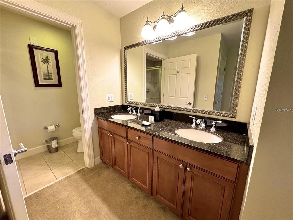 1350 Centre Ct Ridge Drive, Unit 101 Reunion, FL 34747 - Photo 5 of 9 a bathroom with a sink and a mirror