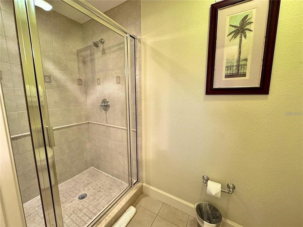 1350 Centre Ct Ridge Drive, Unit 101 Reunion, FL 34747 - Photo 7 of 9 a bathroom with a glass shower door
