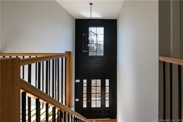 a view of an empty room and window and wooden floor