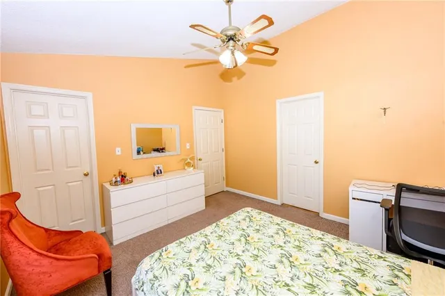 a spacious bedroom with a bed and a chandelier