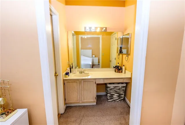 a bathroom with a granite countertop sink and a mirror