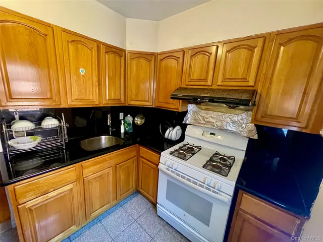 a kitchen with granite countertop cabinets and black appliances