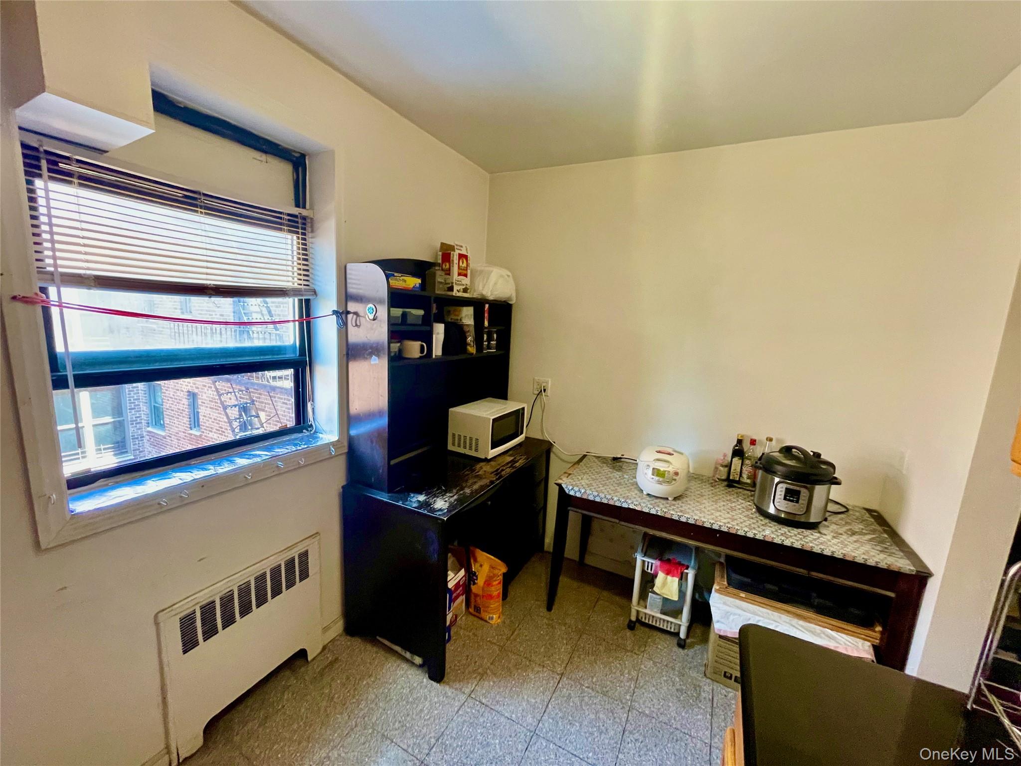 44-25 Macnish Street, Unit 5B Queens, NY 11373 - Photo 14 of 19 a room with furniture and window
