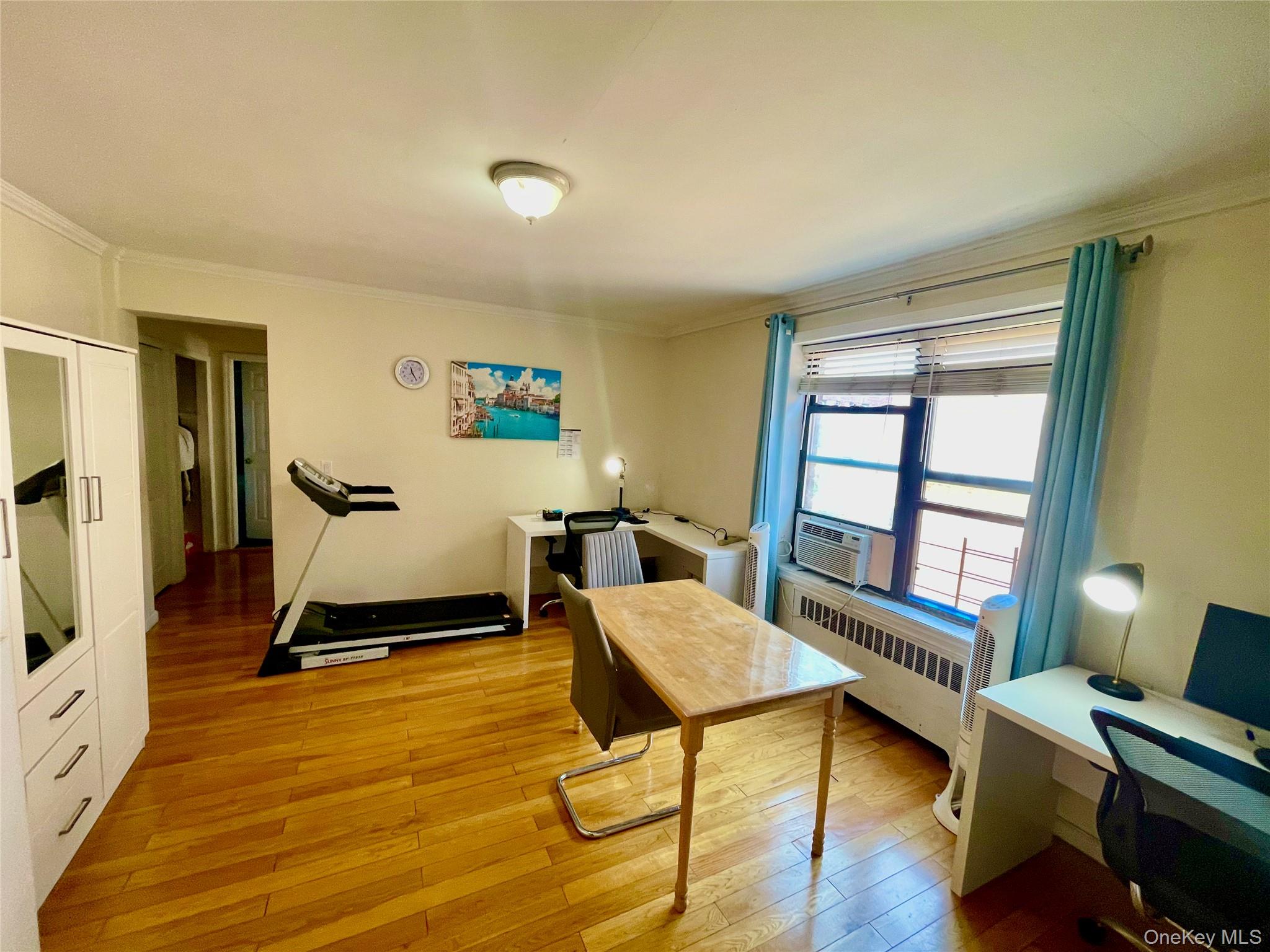 44-25 Macnish Street, Unit 5B Queens, NY 11373 - Photo 7 of 19 a living room with furniture a window and a flat screen tv