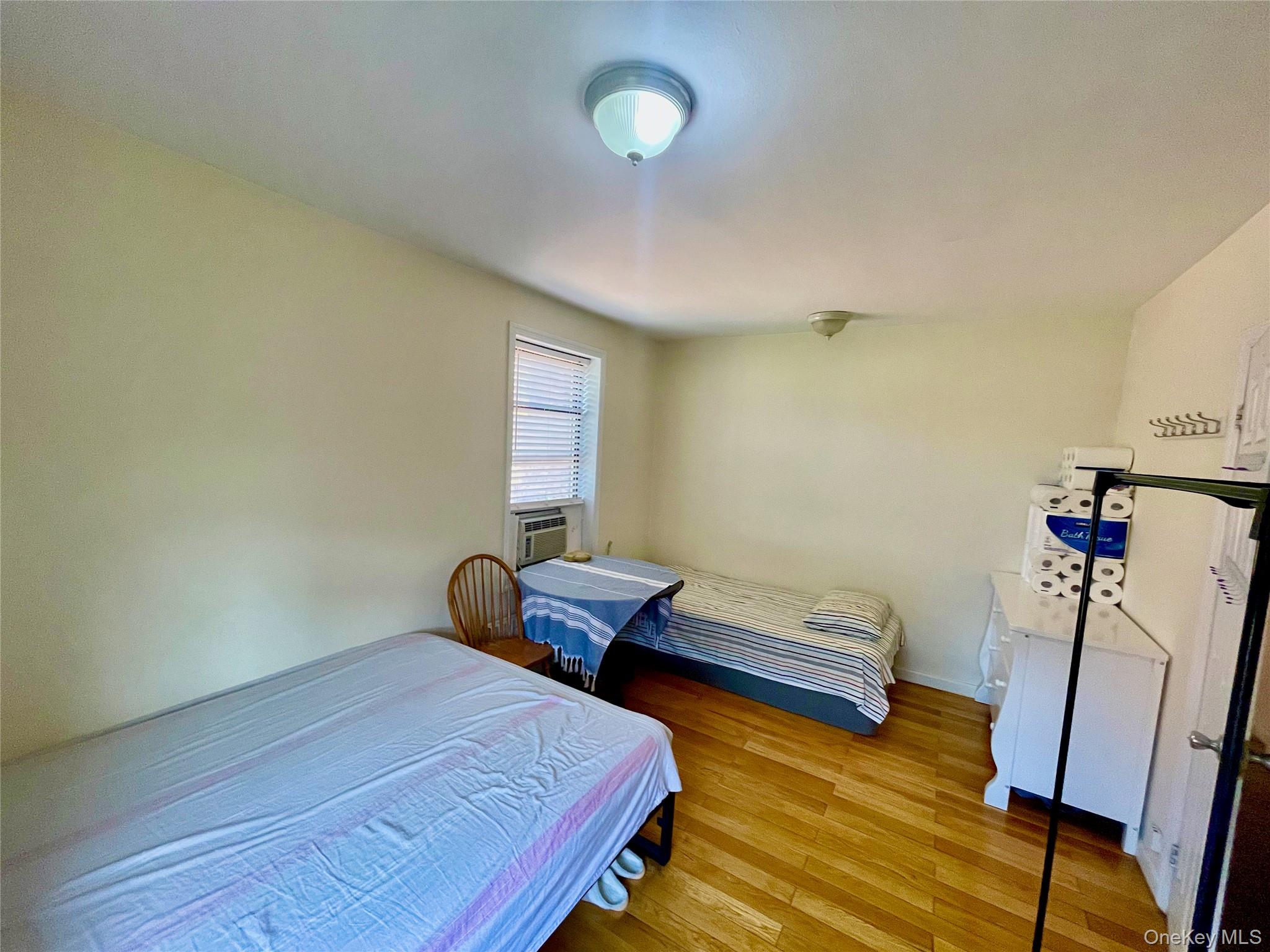 44-25 Macnish Street, Unit 5B Queens, NY 11373 - Photo 9 of 19 a bedroom with two beds and a desk