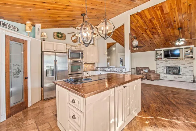 a kitchen with stainless steel appliances granite countertop a sink and cabinets